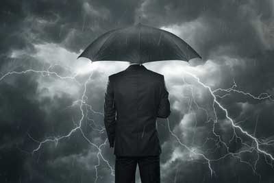 man in umbrella facing storm